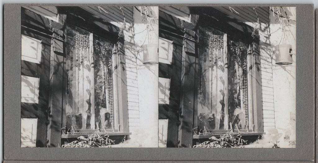 Winter Zero's Bottle Farm, window with hanging bauble and bottles, October 12, 1939