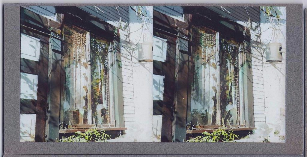 Winter Zero's Bottle Farm, window with hanging bauble and bottles colorized, October 12, 1939